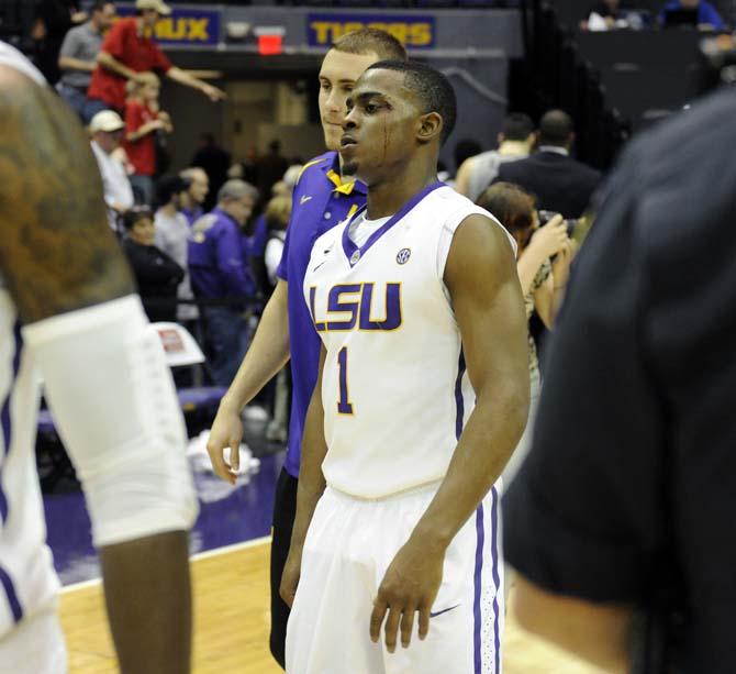 A bloddied Anthony Hickey (1) walks off the court Saturday, March 8, 2014 following the Tigers' 61-69 loss to Georgia in the PMAC.