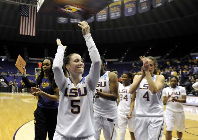 LSU senior guard Jeanne Kenney (5) celebrates with her team Sunday, March 23, 2014, after the Tigers' 98-78 victory against Georgia Tech in the PMAC.