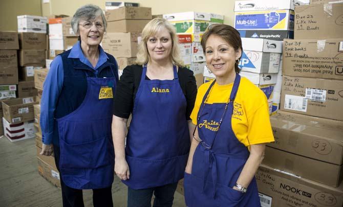 Joan Tapp (left), Alana Amaro (center) and Anita Adams (right), workers at the LSU Book Barn, volunteer at the LSU Libraries Friends of the Libraries Annual Book Bazaar on Thursday, March 20, 2014 in the 4-H mini barn.