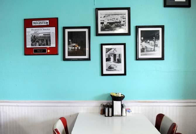 Photos of a previous location of Louie's Café hang on the wall of the restaurant Sunday, March 23, 2014.