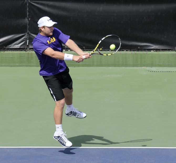 LSU sophomore Andrew Korinek returns a serve Friday, March 7, 2014 during a doubles match against Alabama in W.T. "Dub" Robinson Stadium.