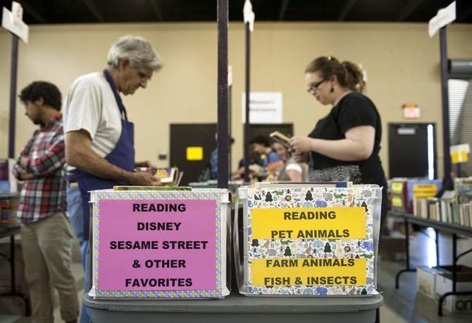 Shoppers look at books displayed on a table at the LSU Libraries Friends of the Libraries Annual Book Bazaar on Thursday, March 20, 2014 in the 4-H mini barn.