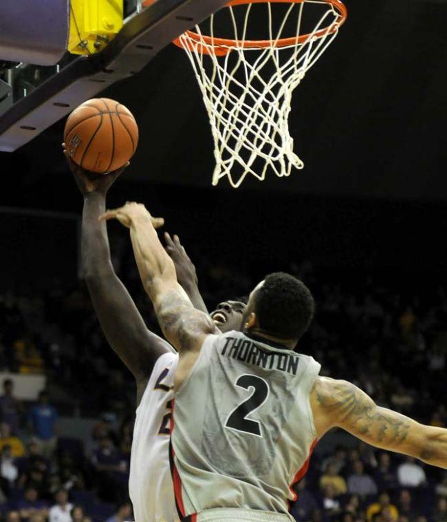 LSU junior forward Johnny O'Bryant III (2) tries to shoot around Georgia junior forward Marcus Thornton (2) on Saturday March 8, 2014 during the Tigers' 61-69 loss to the Bulldogs in the PMAC.