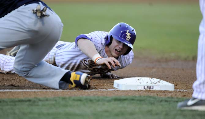 LSU freshman outfielder Jake Fraley (23) attempts to slide into third base Wednesday, March 3, 2014 during the Tigers' 8-0 victory against Southern in Alex Box Stadium.