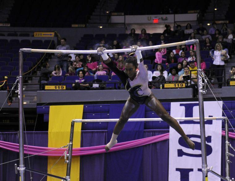 All-around gymnast Britney Ranzy performs her uneven bar routine Friday, March 7, 2014 during the Tigers' 197.500 - 195.525 victory against NC State in the Pete Maravich Assembly Center.