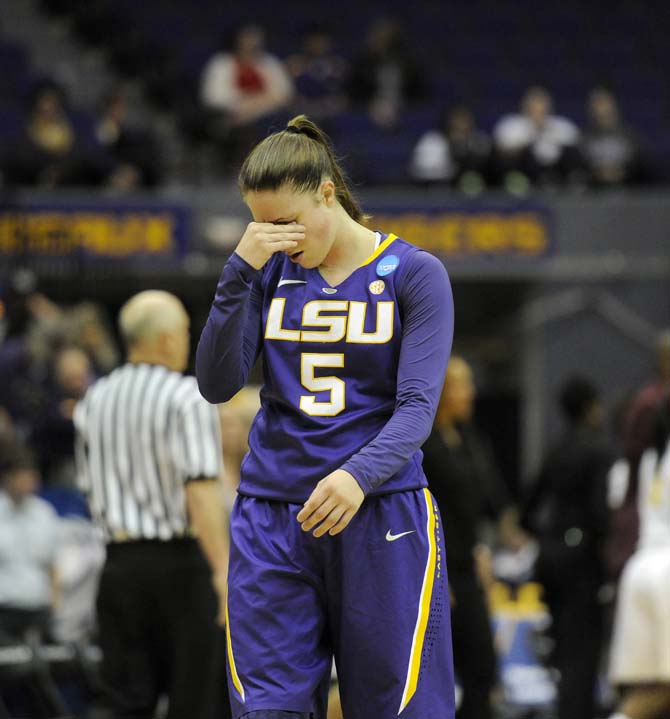 LSU senior guard Jeanne Kenney (5) holds her head Tuesday, March 25, 2014, during the Lady Tigers' 76-67 win against West Virginia in the PMAC. She left the game in the first half and did not return.