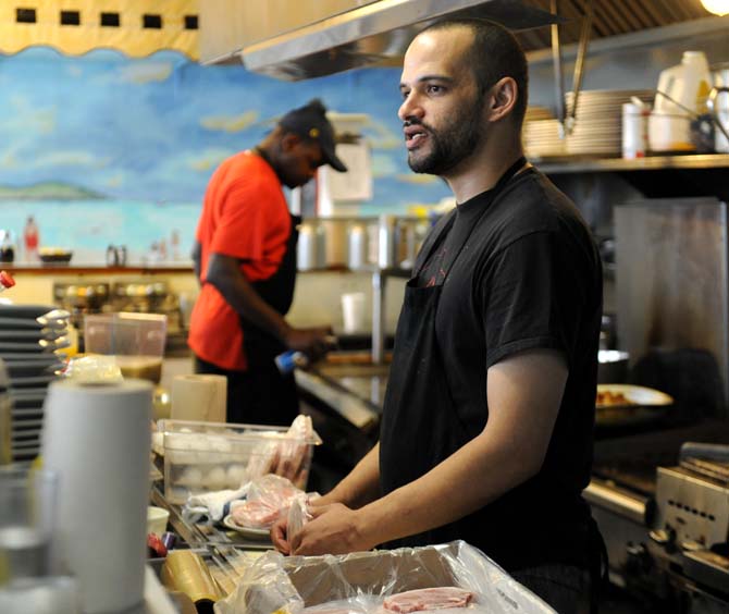 Fry cook and manager Jeremy Lewis works in the kitchen Sunday, March 23, 2014 at Louie's Café.