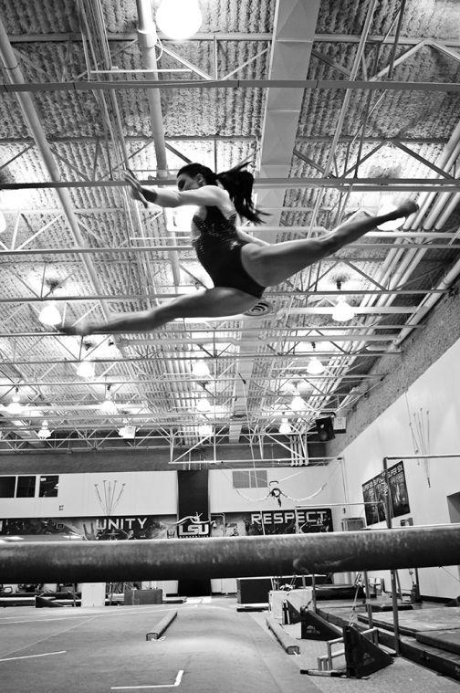 Rheagan Courville jumps on the balance beam.