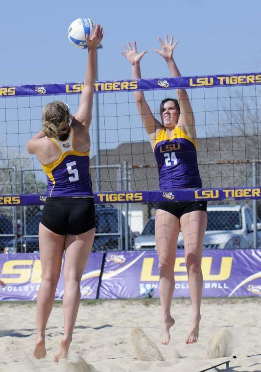 LSU sophomore Cati Leak (24) jumps to block a spike from fellow sophomore Katie Lindelow Wednesday, March 12, 2014 during the Tigers' scrimmage at Mango's Outdoor Volleyball.