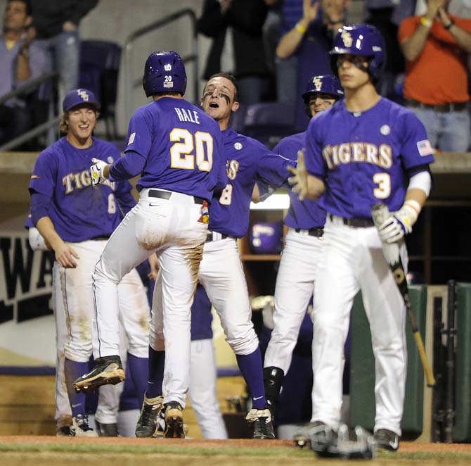 LSU junior infielder Connor Hale (20) celebrates with sophomore infielder Alex Bregman (8) after Hale scored Saturday, March 8, 2014 during the Tigers' 4-2 victory against Purdue at Alex Box Stadium.