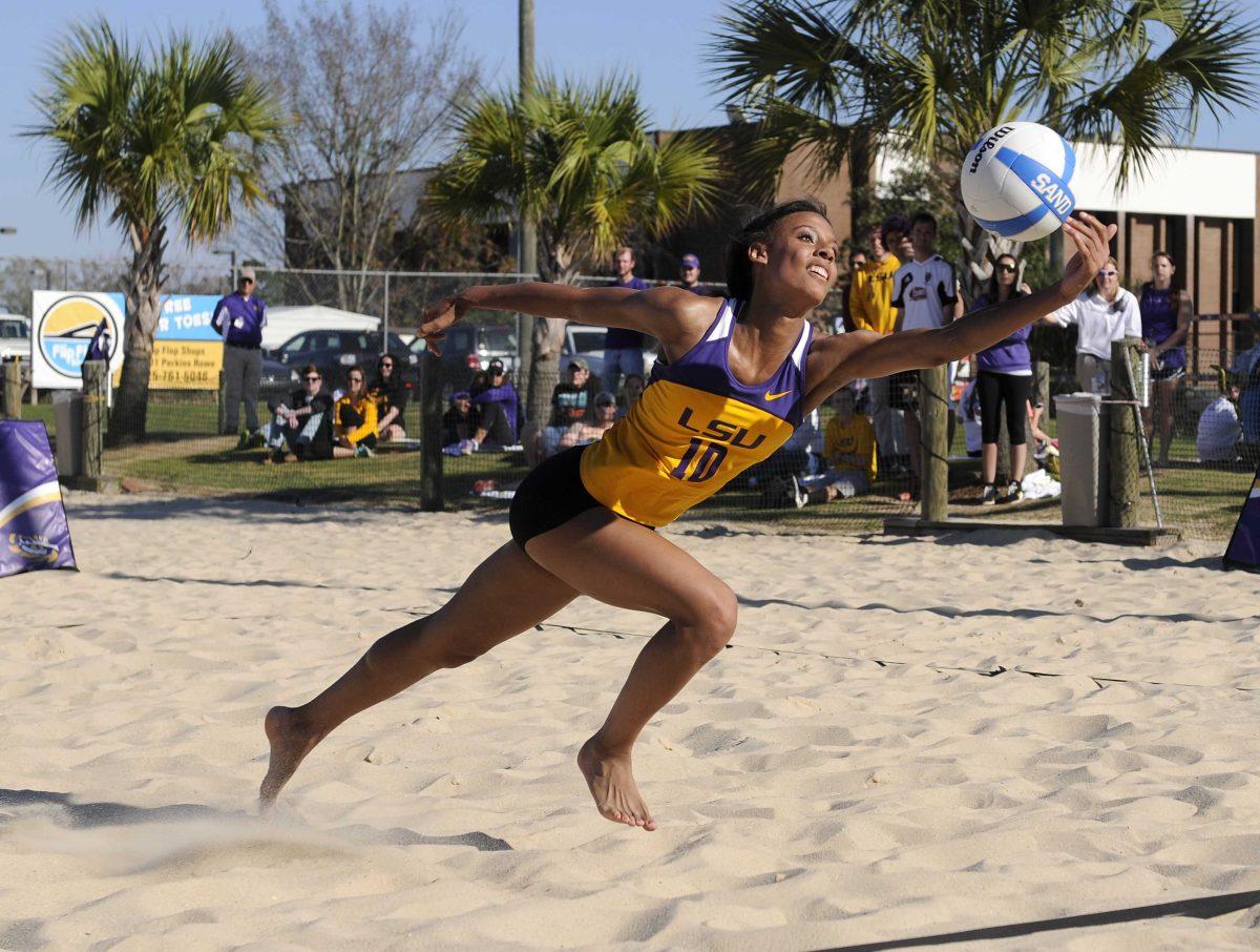 LSU fresman Mimi Eugene (10) lunges to hit the ball Tuesday, March 18, 2014, during the Tigers' 2-3 loss to ULM at Mango's Outdoor Volleyball.