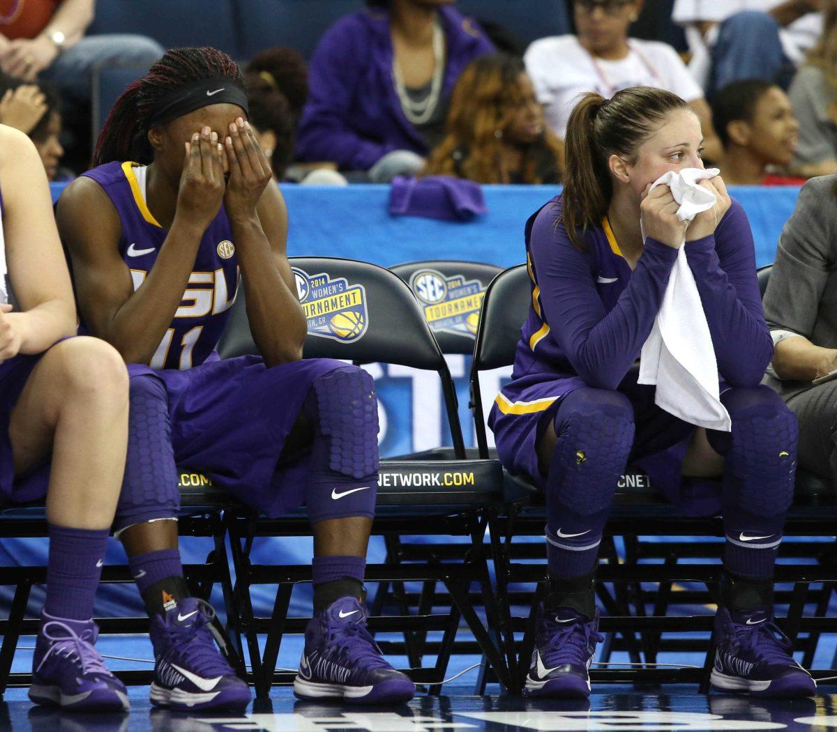 LSU guard Raigyne Moncrief, left, and guard Jeanne Kenney react on the bench in the closing minute of the team's to Tennessee in an NCAA college basketball game in the quarterfinals of the Southeastern Conference women's tournament, Friday, March 7, 2014, in Duluth, Ga. Tennessee defeated LSU 77-65. (AP Photo/Jason Getz)