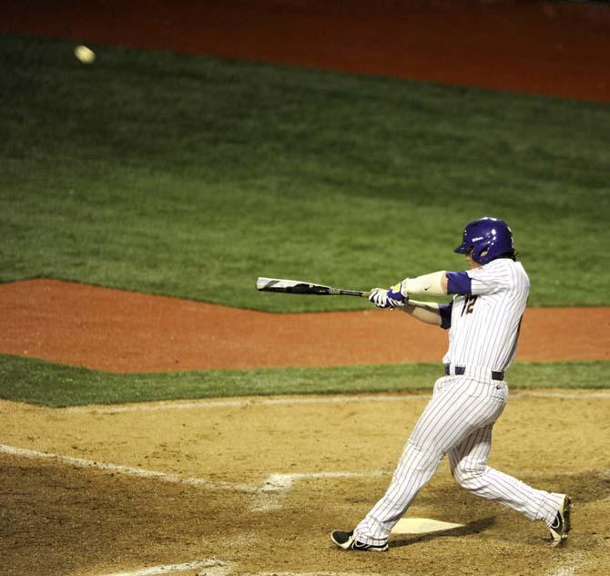 LSU junior catcher Kade Scivicque (22) hits the ball Tuesday, March 11, 2014 during the Tigers' 5-3 win against Nicholls State in Alex Box Stadium.