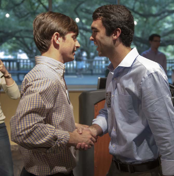 Newly-elected Student Government president Clay Tufts of The Next Step (right) shakes hands with his opponent, Christian Coleman of Experience LSU (left), on Wednesday, March 26, 2014, following the election result announcement in the Student Union.