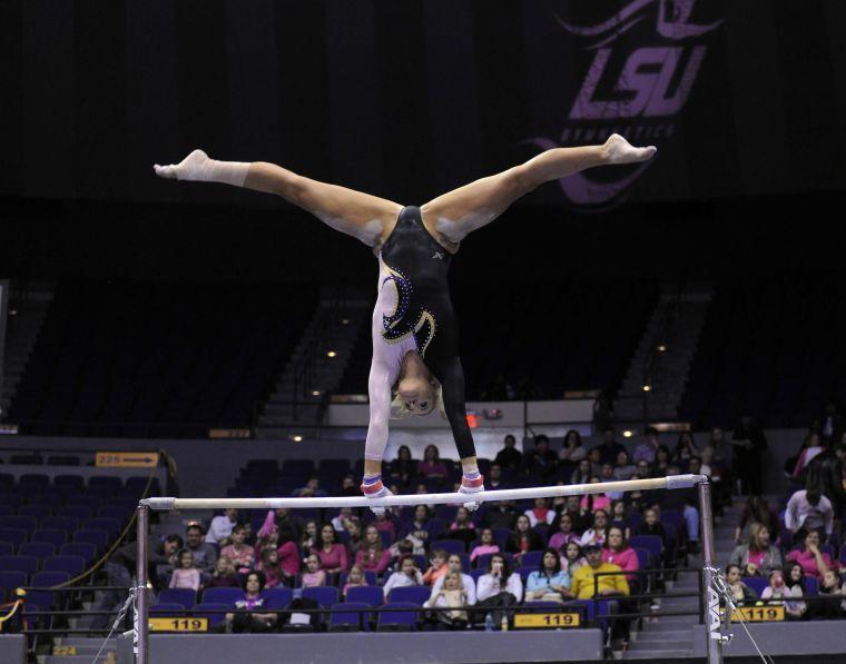 All-around gymnast Sarie Morrison performs her uneven bar routine Friday, March 7, 2014 during the Tigers' 197.500 - 195.525 victory against NC State in the Pete Maravich Assembly Center.