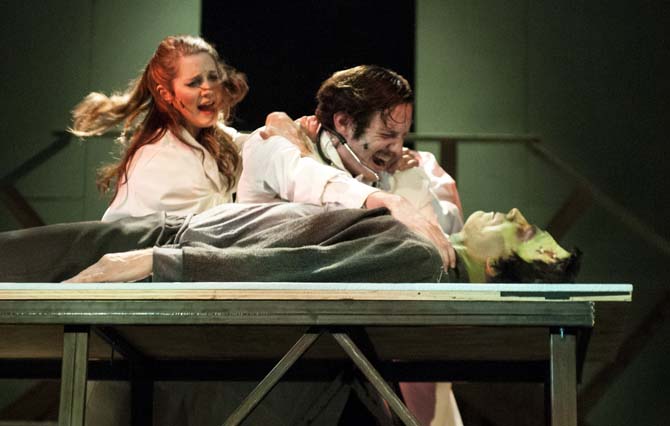 Inga played by Marlo Dupre (left) tries to stop Dr. Fredrick Frankenstein played by Zac Thriffiley (right) from suffocating the monster played by Lance Parker (bottom) on Monday, March 11, 2014 during a dress rehearsal for Young Frankenstein at Theatre Baton Rouge.