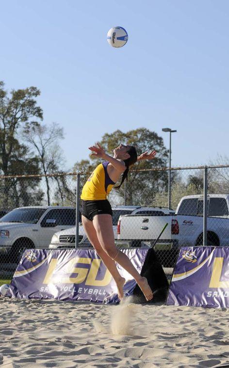 LSU sophomore Victoria Boraski (12) jumps to serve the ball Tuesday, March 18, 2014, during the Tigers' 2-3 loss to ULM at Mango's Outdoor Volleyball.