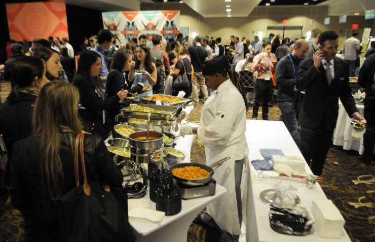 TribeFest attendees fill their plates at the pasta bar during the Purim seudah meal Sunday, March 16, 2014 at the Sheraton New Orleans Hotel.