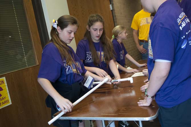 Students from St. Aloysius Academy assemble a rocket launcher Friday, March 28, 2014,