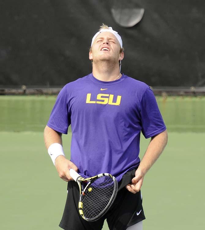 LSU sophomore Andrew Korinek reacts after losing a point Friday, March 7, 2014 during a doubles match against Alabama in W.T. "Dub" Robinson Stadium.