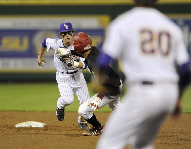 LSU freshman infielder Kramer Robertson (3) runs to tag a Nicholls State player out Tuesday, March 11, 2014 during the Tigers' 5-3 win against the Colonels in Alex Box Stadium.