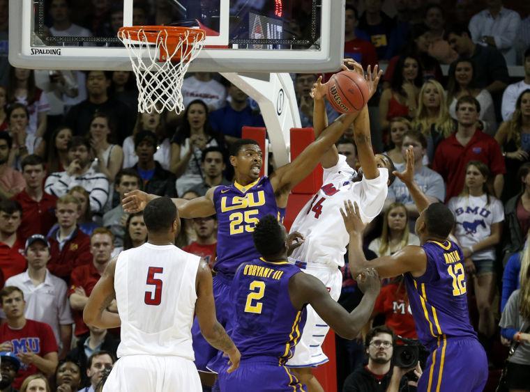 LSU forward Jordan Mickey (25) and SMU forward Ben Moore (34) fight for a rebound during the first half of an NCAA college basketball game in the second round of the NIT Monday, March 24, 2014, in Dallas, Texas. (AP Photo/Sharon Ellman)