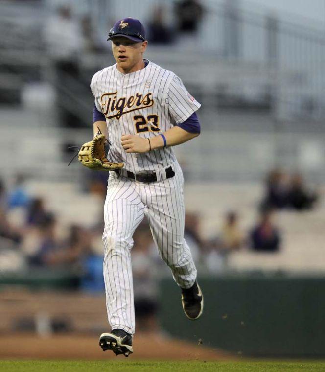 LSU freshman outfielder Jake Fraley runs to the dugout between innings Wednesday, March 19, 2014 during the Tigers' victory against South Alabama at Alex Box Stadium.