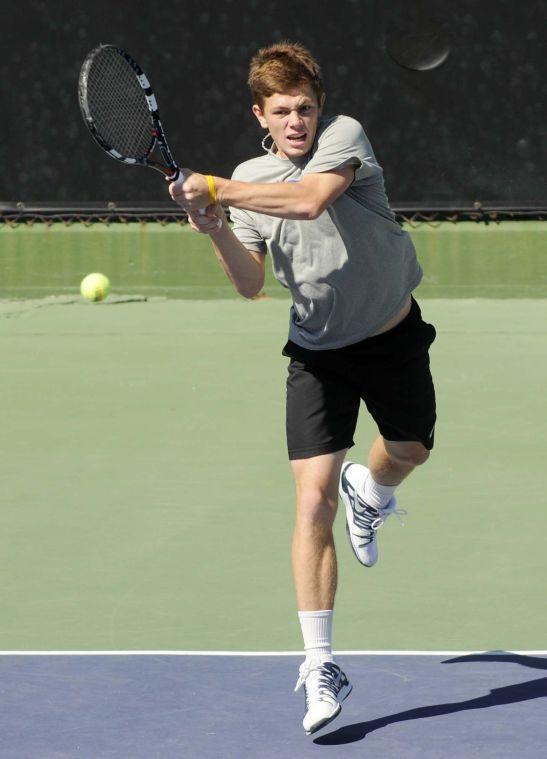 LSU junior Chris Simpson smacks the ball during a match against George Washinton University on March 13, 2014 at the W.T. &#8220;Dub&#8221; Robinson Stadium.