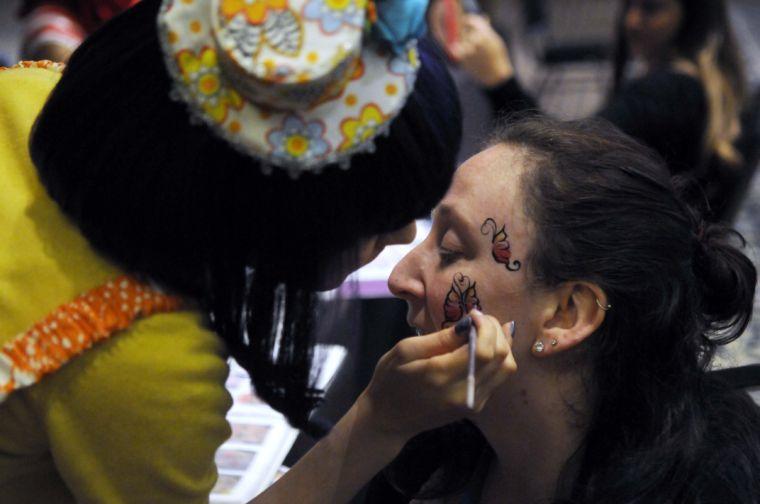 A festival attendee gets her face painted at TribeFest on Sunday, March 16, 2014 at the Sheraton New Orleans Hotel.