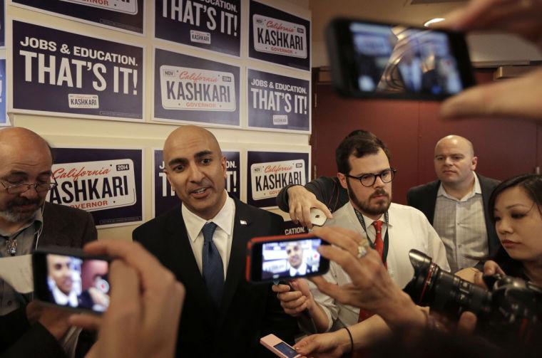 Gubernatorial candidate Neel Kashkari, second from left, speaks with reporters at the California Republican Party 2014 Spring Convention Saturday, March 14, 2014, in Burlingame, Calif. (AP Photo/Ben Margot)