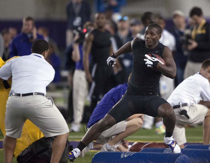 LSU senior running back Alfred Blue (4) participates in the running back drill on Wednesday, April 9, 2014 during LSU Pro Day in the LSU Indoor Practice Facility.