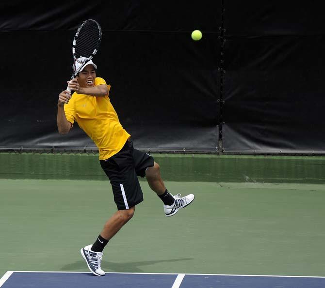 LSU sophomore Tam Trinh returns a volley Sunday, March 30, 2014 during the Men's Tennis doubles match against Florida at W.T. "Dub" Robinson Stadium.