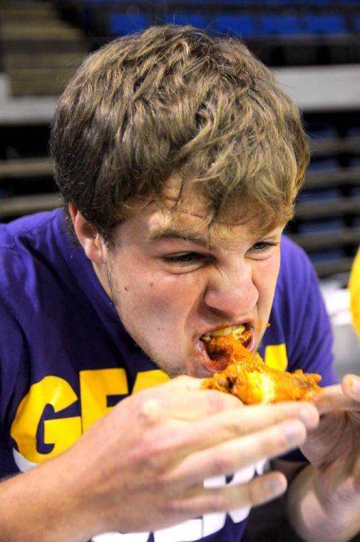 Contestant Andrew Badeaux bites into a wing during a hot wing eating contest Saturday, April 26, 2014 during the first annual Louisiana Wing-a-thon at the Baton Rouge River Center.