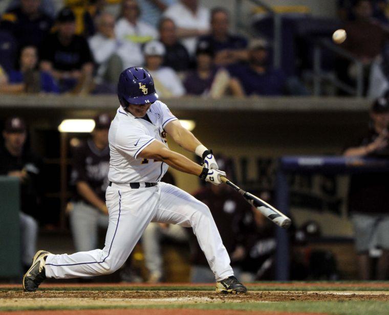 LSU senior infielder Christian Ibarra (14) hits the ball during the Tigers' 3-0 victory against Mississippi State on Friday, April 4, 2014 at Alex Box Stadium.