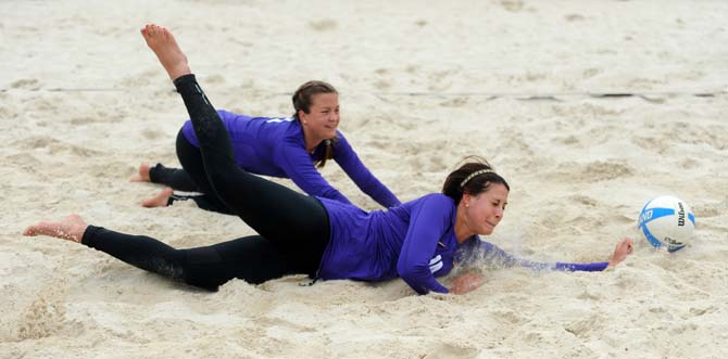 LSU junior sand volleyball player Malorie Pardo (14) dives for the ball Wednesday, March 26, 2014, during the Tigers' 3-2 lost against Tulane at Coconut Beach Sand Volleyball Complex.