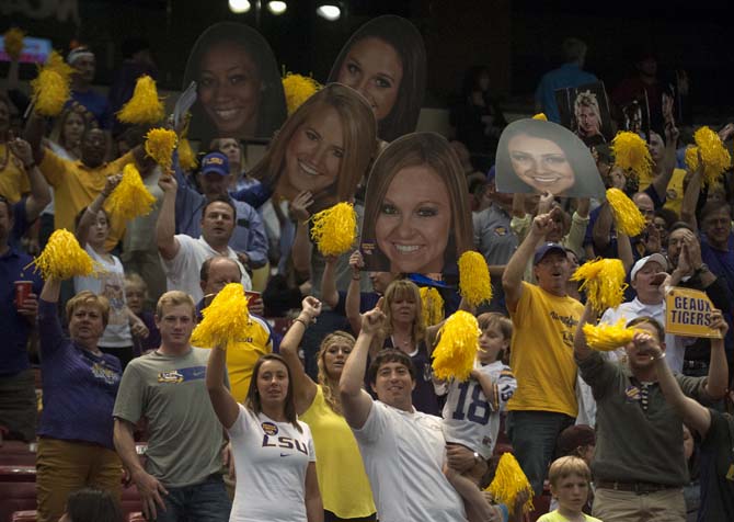 LSU fans in the stands hold giant cutouts of gymnasts' faces Saturday, April 19, 2014 during the NCAA Super Six Finals in Birmingham, Ala.