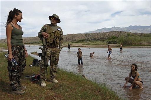 Jennifer Scalzo, left, and her husband Anthony Scalzo stand by the Virgin River during a rally in support of Cliven Bundy near Bunkerville, Nev. Friday, April 18, 2014. (AP Photo/Las Vegas Review-Journal, John Locher)