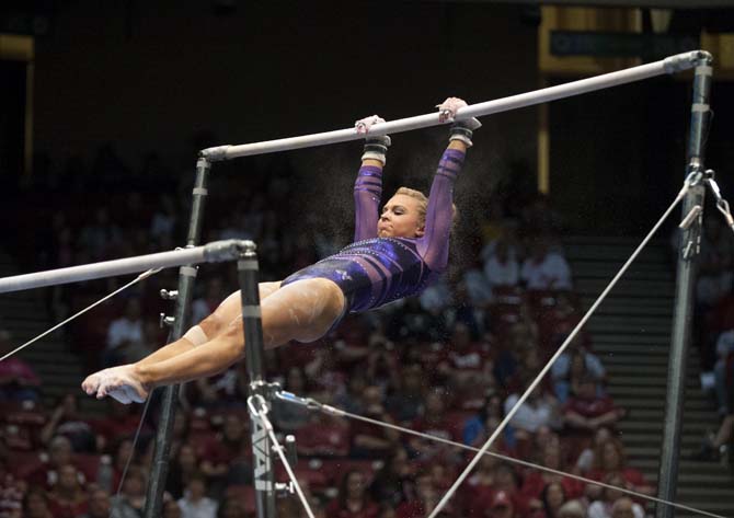 LSU senior all-around gymnast Kaleigh Dickson swings on the bars Saturday, April 19, 2014 during the first rotation of the NCAA Super Six Finals in Birmingham, Ala.