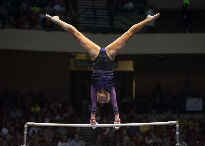 LSU senior all-around gymnast Sarie Morrison swings on the bars Saturday, April 19, 2014 during the first rotation of the NCAA Super Six Finals in Birmingham, Ala.