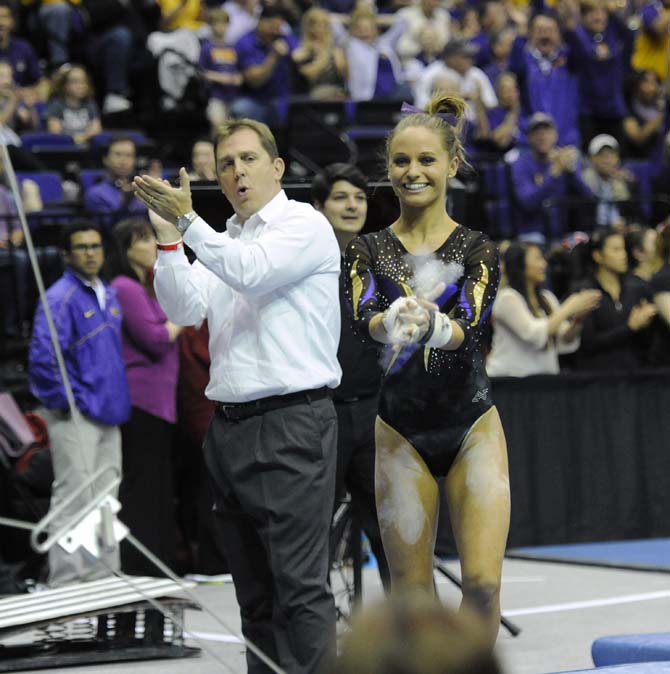 LSU gymnastics associate head coach Jay Clark celebrates after junior all-around Jessie Jordan's bar routine Saturday, April 5, 2014, during an NCAA Gymnastics Regional in the PMAC.