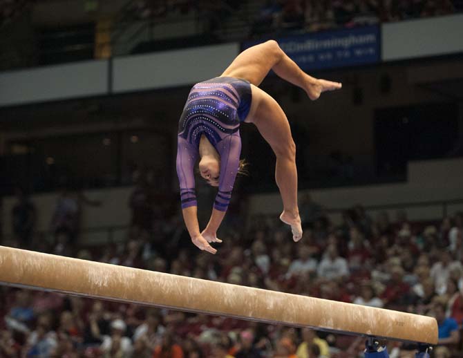 LSU freshman all-around gymnast Ashleigh Gnat flips on the beam Saturday, April 19, 2014 during the second rotation of the NCAA Super Six Finals in Birmingham, Ala.