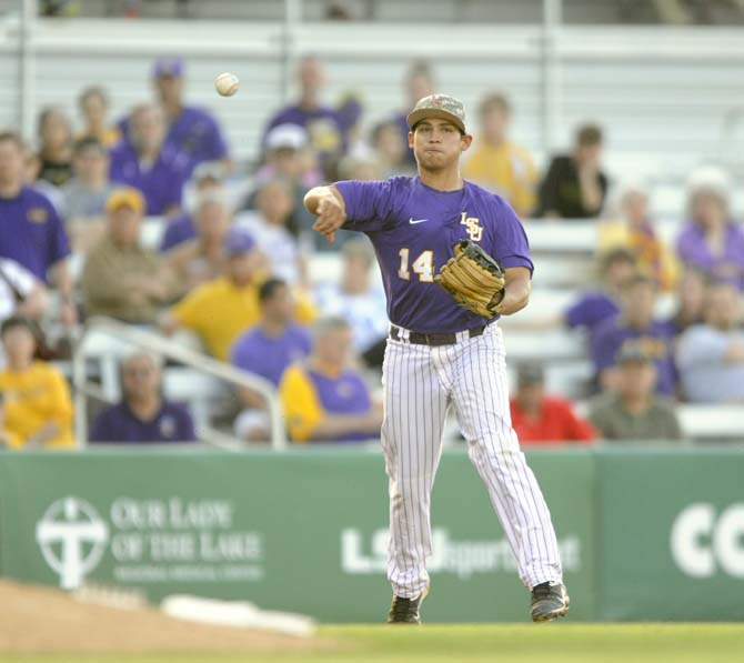 LSU senior infielder Christian Ibarra (14) throws toward first base Tuesday, April 22, 2014, during the Tigers' 6-0 win against Tulane in Alex Box Stadium.