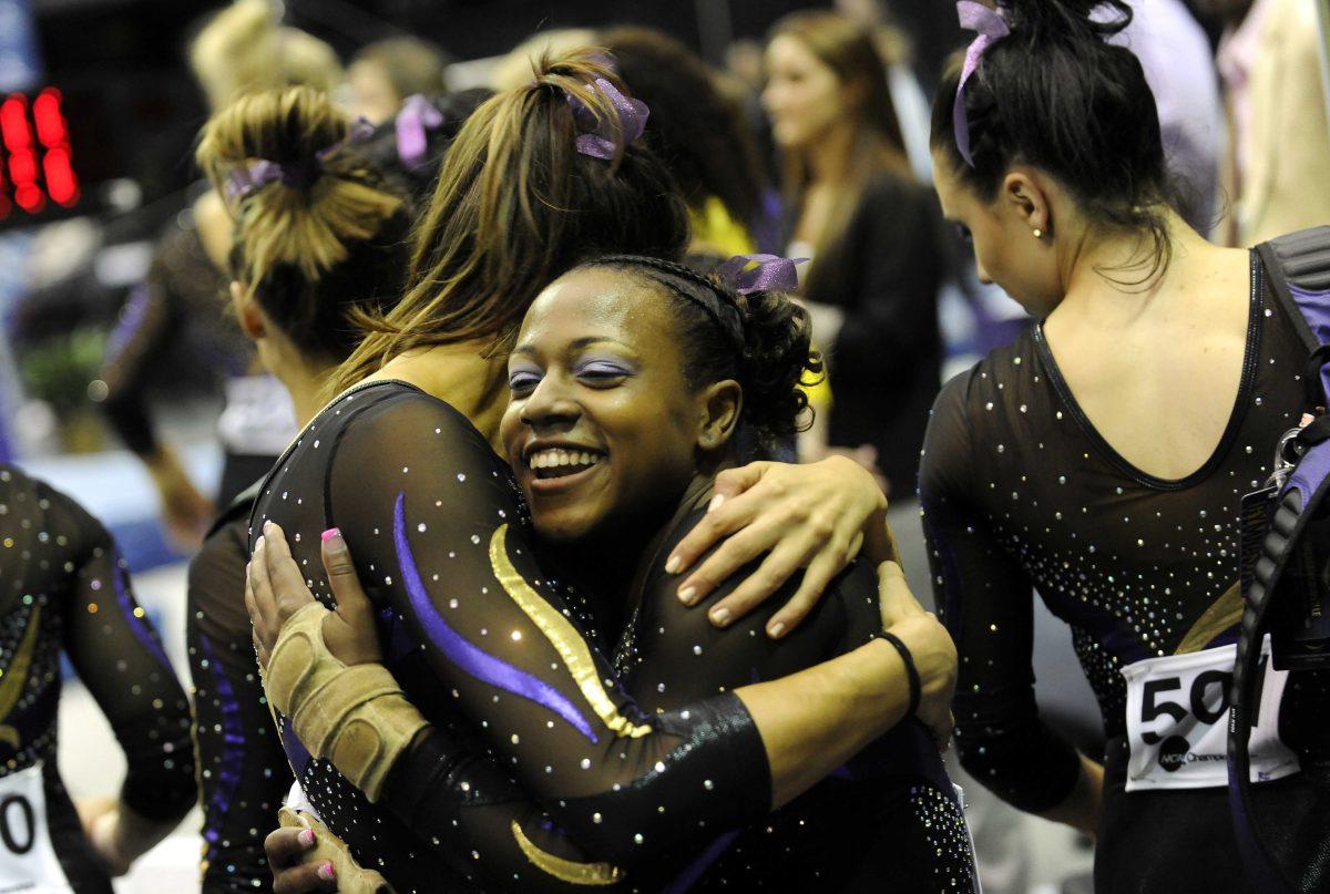 LSU junior all-around gymnast Lloimincia Hall celebrates with teammates Saturday, April 5, 2014 after receiving a perfect 10 on her floor routine during the NCAA Gymnastics Regional in the PMAC. LSU won the regional with a score of 198.325.