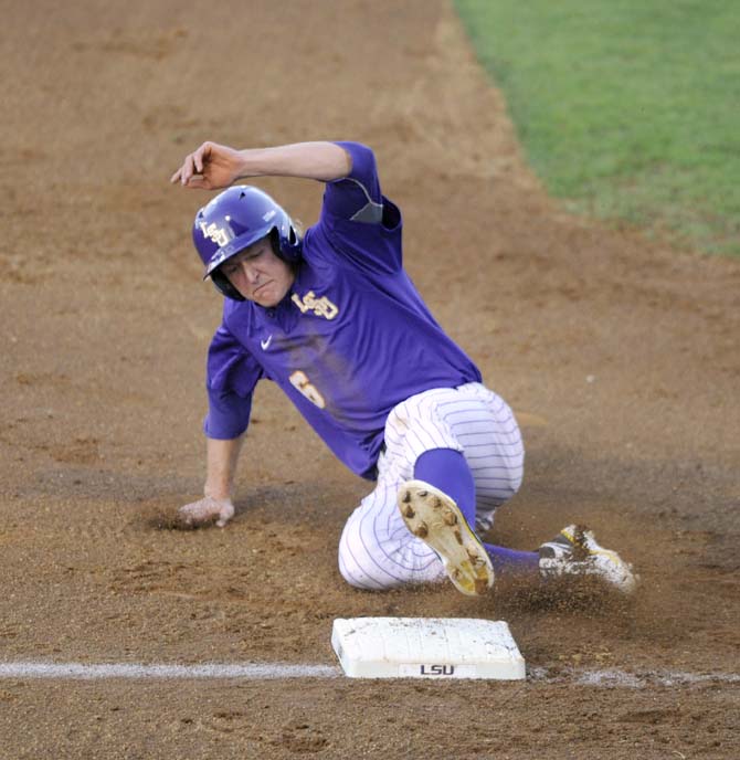 LSU sophomore outfielder Andrew Stevenson (6) slides into third base Tuesday, April 22, 2014, during the Tigers' 6-0 win against Tulane in Alex Box Stadium.