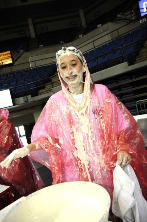 A contestant in the bobbing for wings competition attempts to remove ranch sauce from her face Saturday, April 26, 2014 during the first annual Louisiana Wing-a-thon at the Baton Rouge River Center.