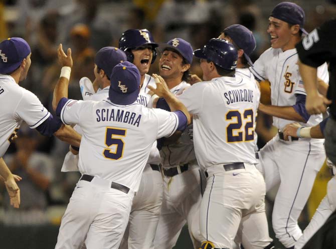 LSU sophomore outfielder Mark Laird is swarmed by teammates on Friday, Aptil 25, 2014, after his walk off single to carry the Tigers to a 8-7 victory against Tennessee at Alex Box Stadium.