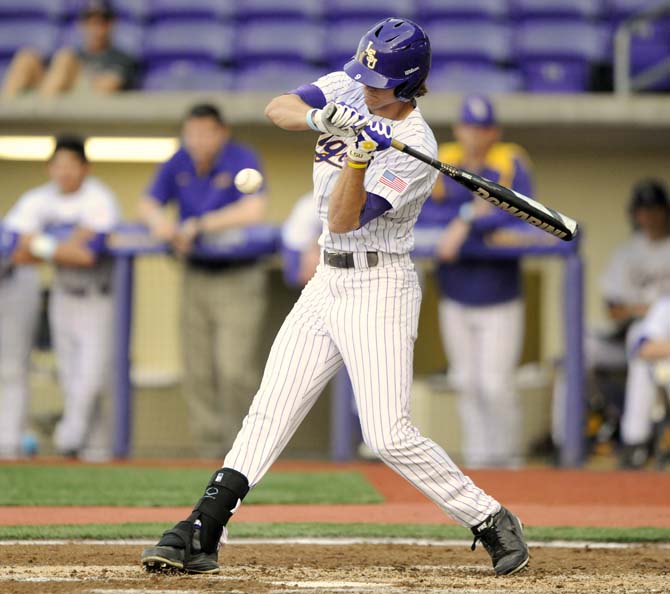 LSU sophomore outfielder Mark Laird (9) swings at the ball Wednesday, April 2, 2014, during the Tigers' 10-3 victory against McNeese in Alex Box Stadium.