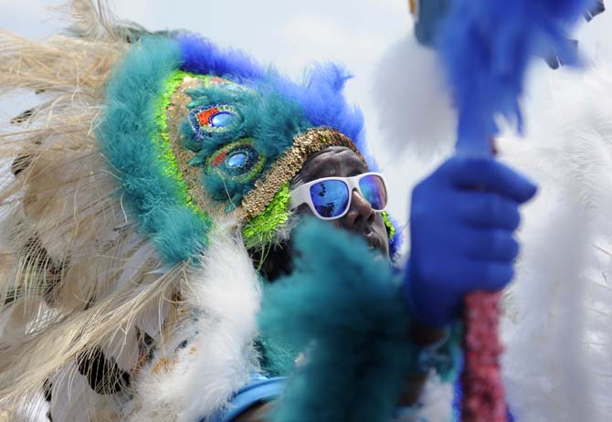 A Mardi Gras Indian sings to festival-goers Saturday, April 26, 2014, during the New Orleans Jazz and Heratige Festival.