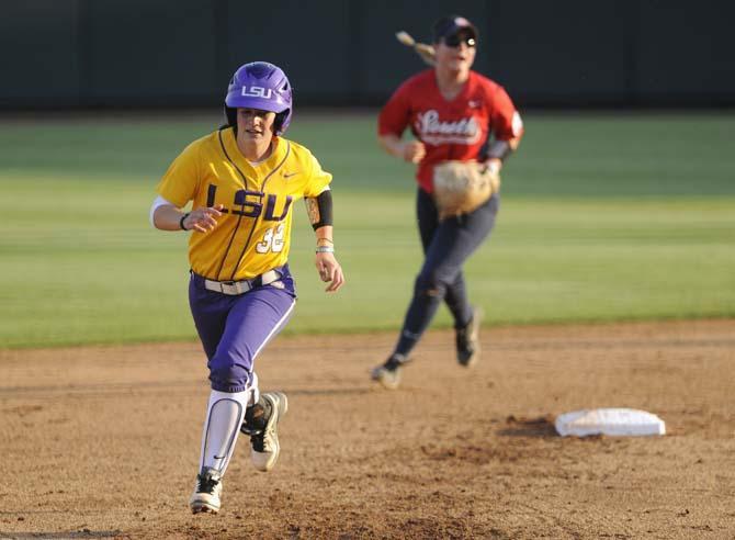 LSU senior infielder Allison Falcon (32) runs toward third base Wednesday, April 23, 2014 during the Lady Tigers' 6-1 victory against the University of South Alabama at Tiger Park.