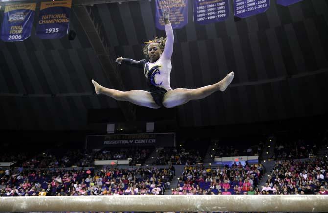 LSU junior all-around gymnast Lloimincia Hall leaps off the beam Friday, March 7, 2014 during the Tigers' 197.500-195.525 victory against NC State in the PMAC.